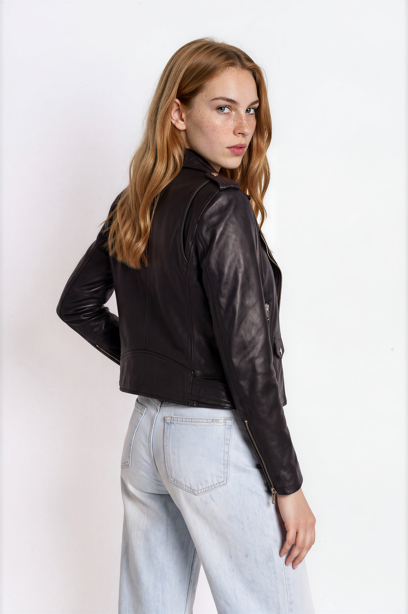 Close-up of shoulder and sleeve fit on a black leather biker jacket